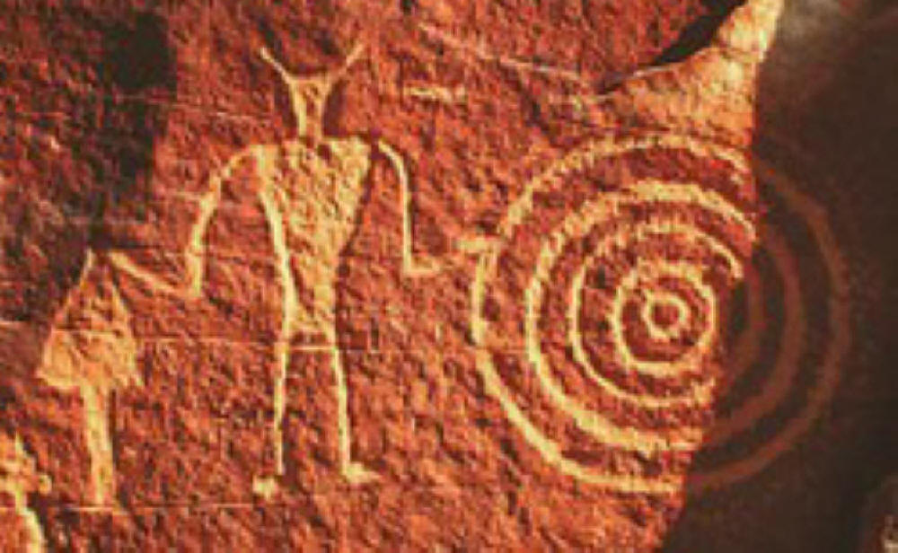 Seems like someone is saying LOOK UP for the Devil and a spiral in this petroglyph